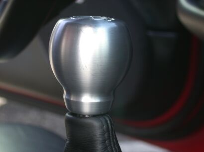 2002 Ford Excursion - A close-up of a brushed metal shifter knob with a leather boot is visible inside a vehicle.