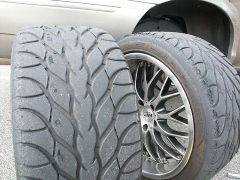 2001 Mercury Grand Marquis - Close-up of two worn performance tires, one mounted on a custom rim.