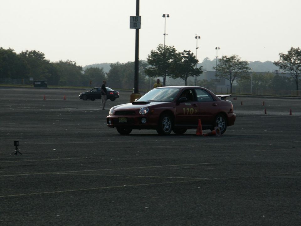 Red sedan with racing number 170 on a track