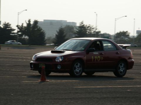 2001 Mercury Grand Marquis - Red Subaru Impreza WRX sedan on a race track, marked with number 170D.