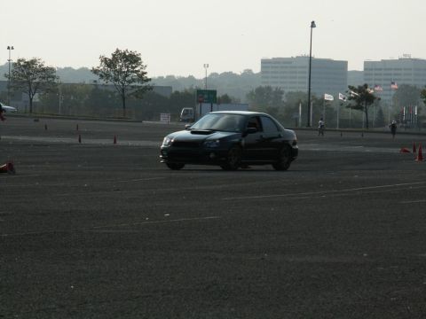 2001 Mercury Grand Marquis - A black sedan navigates a course marked by orange cones on a hazy day.