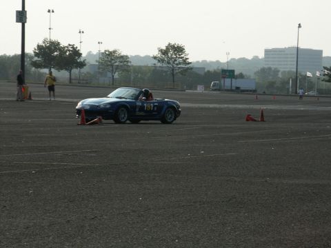 2001 Mercury Grand Marquis - A blue convertible navigates a course marked by traffic cones on a hazy day.
