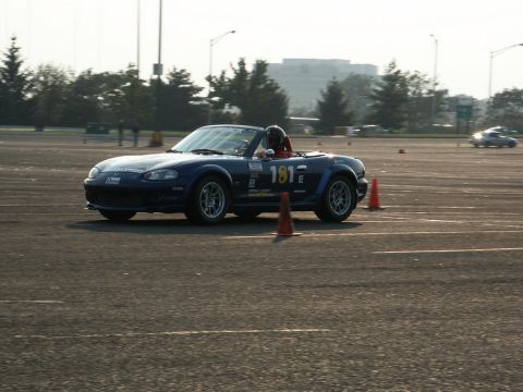 2001 Mercury Grand Marquis - A blue convertible sports car, identified by racing number 181, navigates a course marked by orange cones.