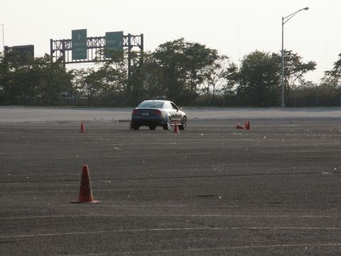 2001 Mercury Grand Marquis - A sedan drives through a cone-marked course, likely for autocross or driver training.