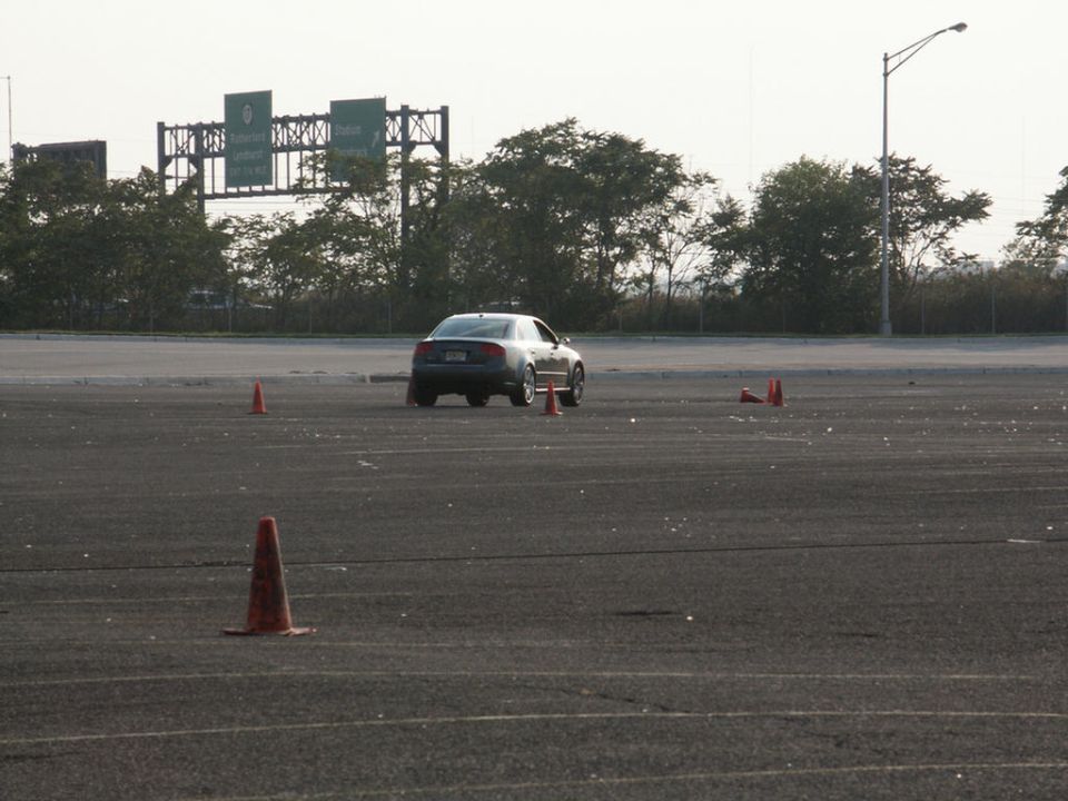 Sedan navigating a course marked by orange cones