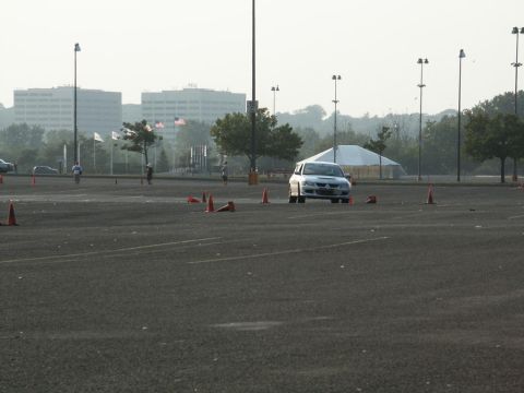 2001 Mercury Grand Marquis - A white sedan navigates a course marked by traffic cones in an open lot.