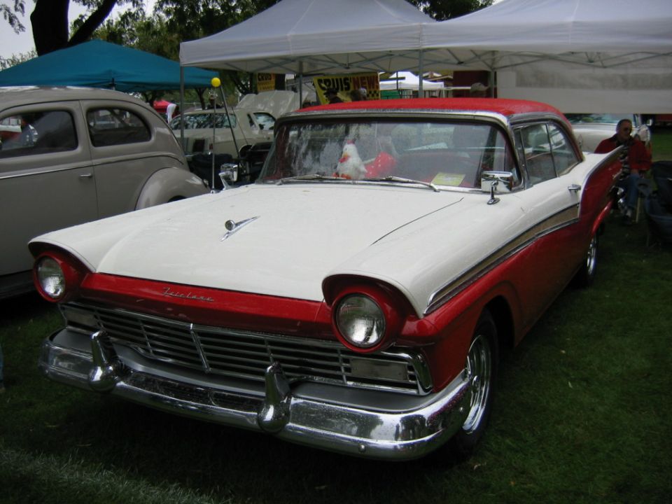 White-over-red 1957 Ford Fairlane hardtop at an outdoor car show