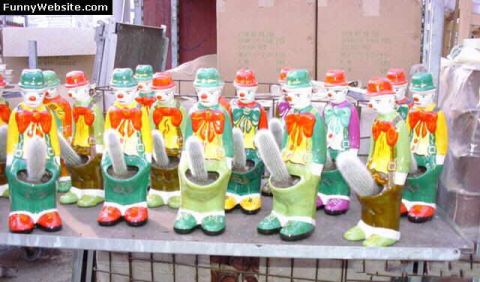1999 Ford Crown Victoria - A collection of novelty clown planters, each containing a cactus, are displayed on a shelf.