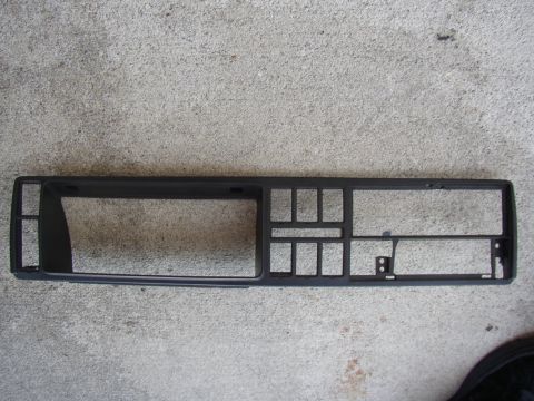 1987 Volkswagen Golf - This is a dashboard trim piece, likely for a car's center console, shown against a concrete surface.