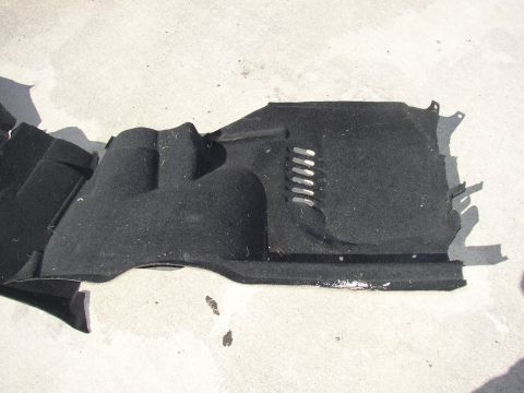 1987 Volkswagen Golf - This is a black automotive underbody shield with some vents and molded sections.