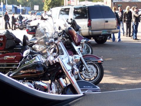 1972 Ford Ranchero - Motorcycles are parked in front of a gold SUV on a sunny day.