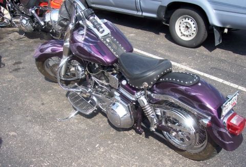 1972 Ford Ranchero - A custom purple motorcycle with flame decals is parked outdoors next to a silver pickup truck.