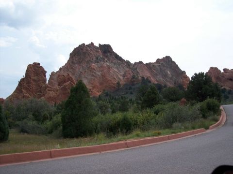 1972 Ford Ranchero - A scenic view of red rock formations with trees and a road in the foreground.