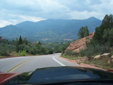 1972 Ford Ranchero - A scenic view of a road winding through mountains on a cloudy day.