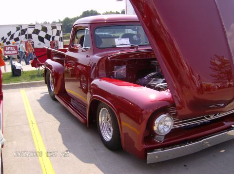 1970 Ford Ranchero - A classic red pickup truck is displayed with its hood open, revealing the engine compartment.