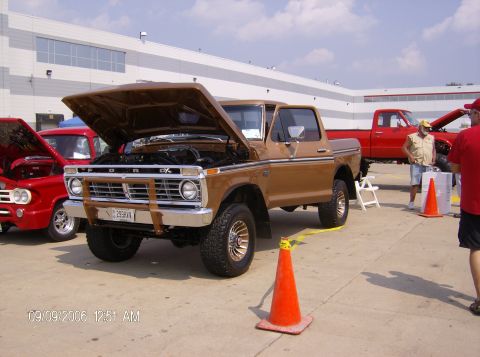 1970 Ford Ranchero - A brown Ford F-Series truck is displayed with its hood open at an outdoor event.