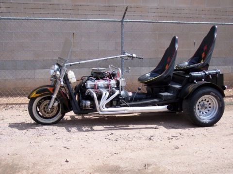 1972 Ford Ranchero - A custom-built trike with a powerful V8 engine and a motorcycle-style front end sits parked outdoors.
