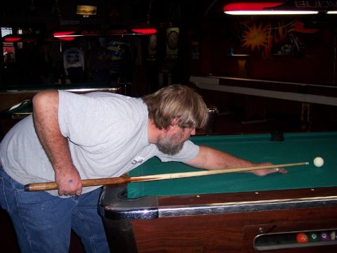 1972 Ford Ranchero - Man plays pool in a dimly lit room with red overhead lights.