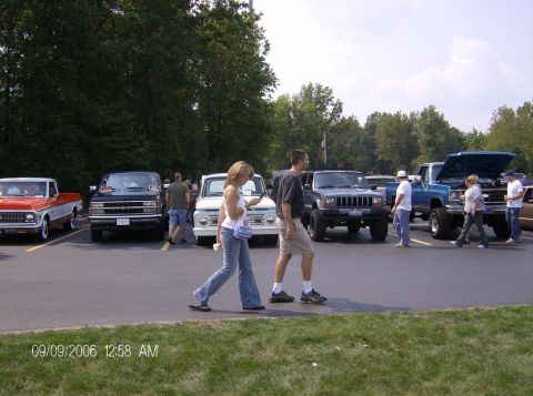 1970 Ford Ranchero - A gathering of trucks and SUVs in a parking lot on a sunny day.