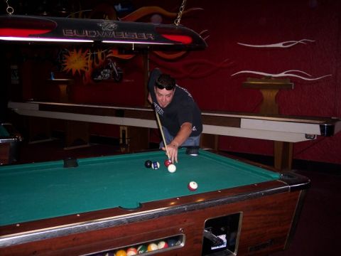 1972 Ford Ranchero - A man plays pool in a dimly lit bar, with a Budweiser sign hanging above the tables.