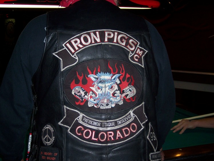 Back of a black leather Iron Pigs MC Colorado motorcycle club vest with flaming boar patch