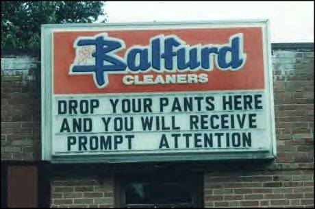 1999 Ford Crown Victoria - A sign for Balfurd Cleaners advertises a humorous message about prompt attention.