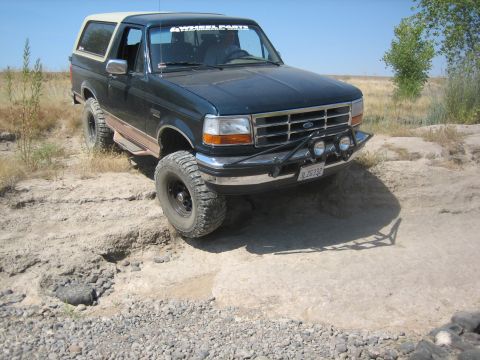 1995 Ford Bronco - This 1995 Ford Bronco is shown navigating a rocky, off-road trail under a clear blue sky.