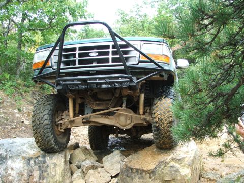 1996 Ford Bronco - This 1996 Ford Bronco is navigating a rocky trail with its front tires on large boulders.