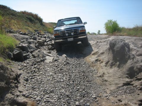 1995 Ford Bronco - This 1995 Ford Bronco tackles a challenging rocky trail, demonstrating its off-road capability.