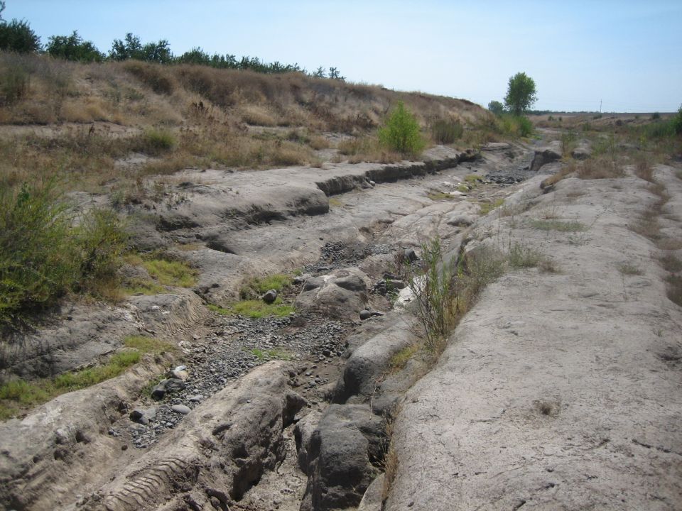 Dry creek bed with tire tracks and Supermotors.net logo