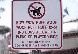 1999 Ford Crown Victoria - This sign prohibits dogs in parks and playgrounds, with a humorous "dog language" message.