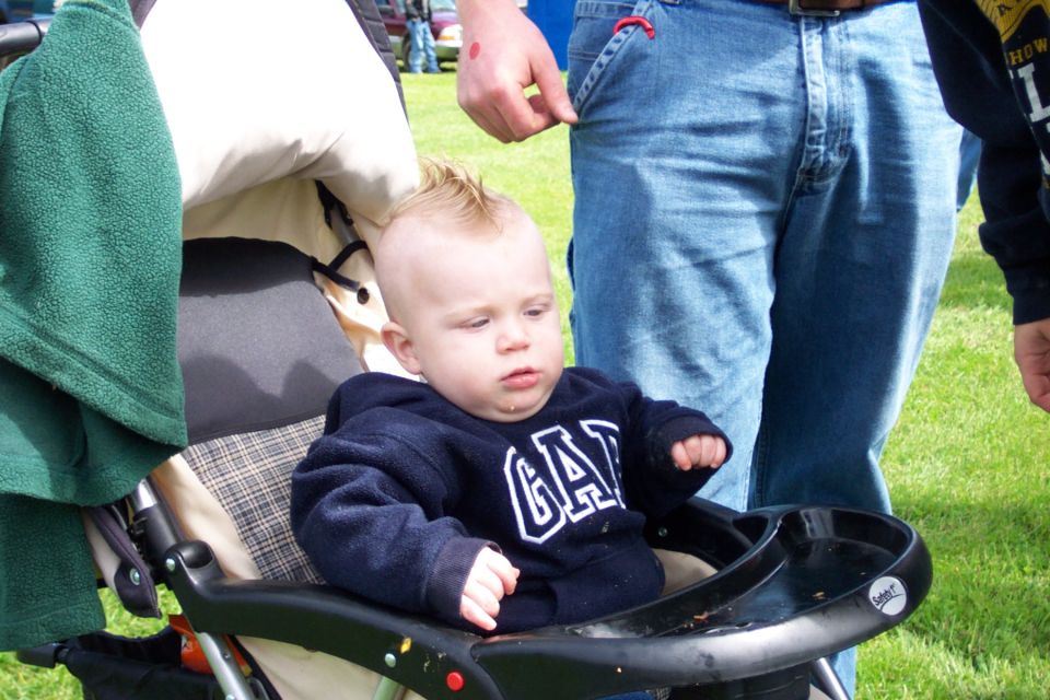 Baby in stroller with mohawk and GAP sweatshirt