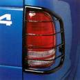 2001 Dodge 2500 - Close-up of a blue truck's rear tail light assembly, showing a protective cage and a partial '4' decal.