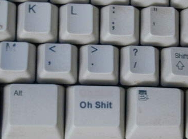 1999 Ford Crown Victoria - A close-up view of a keyboard shows the 'Oh Shit' key prominently displayed.