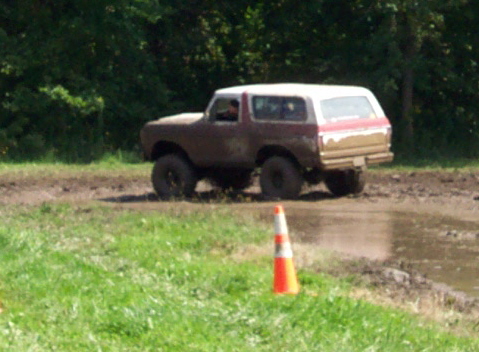 1979 Ford Bronco - This 1979 Ford Bronco navigates a muddy off-road course, showing its capabilities.
