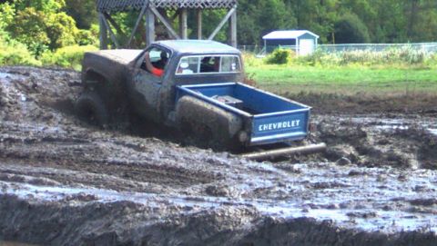 1979 Ford Bronco - Chevrolet pickup truck navigates a muddy obstacle course.