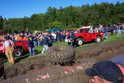1979 Ford Bronco - Spectators gather to watch vehicles participate in a mud bogging event on a sunny day.