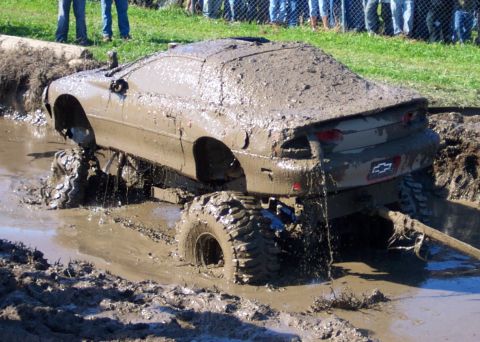1979 Ford Bronco - Car stuck deep in mud during a mud bogging event.