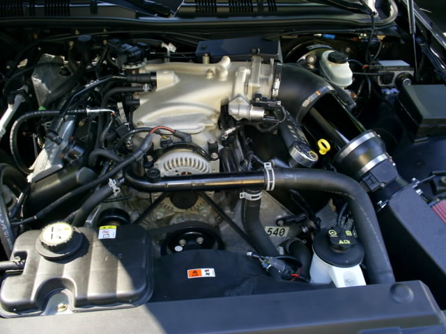 Engine bay with intake system and various hoses visible. Part number 540 is visible on a hose clamp