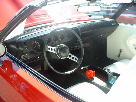 2000 Ford Crown Victoria - Interior view of a red convertible, showing the dashboard, steering wheel, and seats.