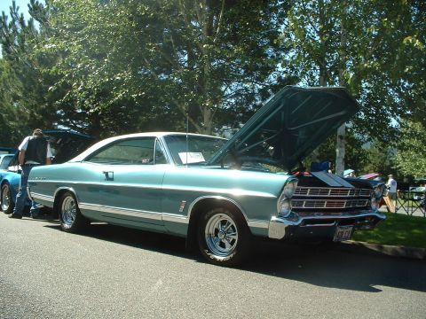 2000 Ford Crown Victoria - This 1967 Ford Galaxie 500 coupe is shown from a three-quarter front angle with its hood open.