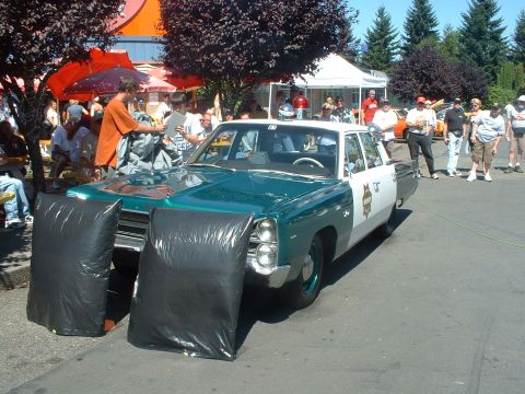 2000 Ford Crown Victoria - This 1967 Plymouth Fury I Sheriff unit is seen with black bags covering its headlights and front fenders.
