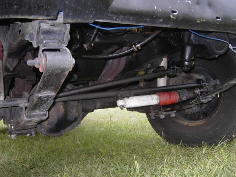 1977 Jeep Wagoneer - A close-up view of the undercarriage, focusing on the suspension components.