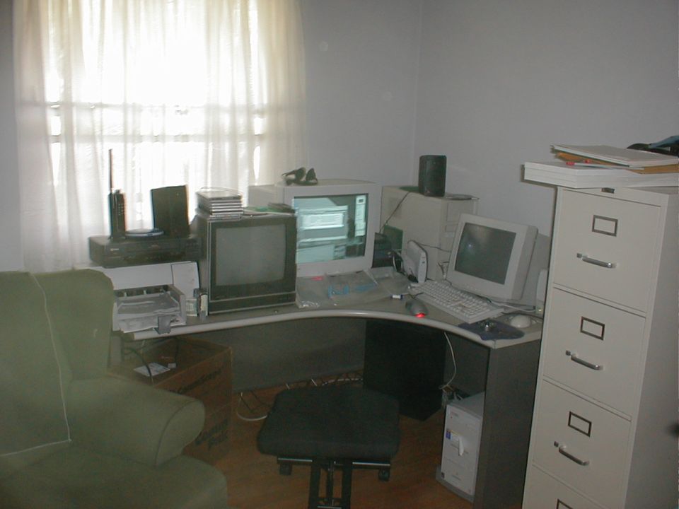 Office scene with computers, filing cabinet, and chair