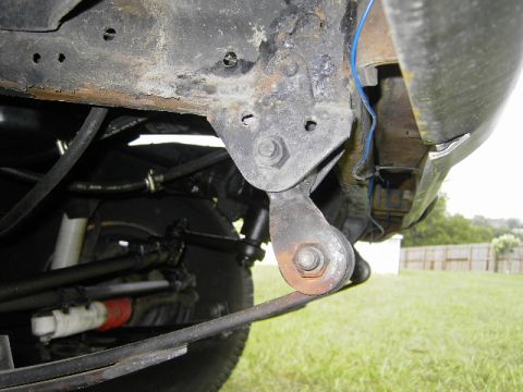 1977 Jeep Wagoneer - Close-up view of the undercarriage, focusing on the suspension and frame structure of an unidentified vehicle.