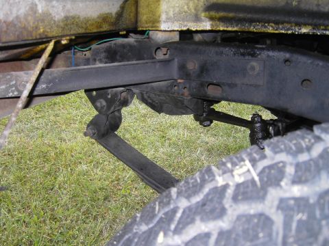 1977 Jeep Wagoneer - Close-up view of the front suspension and chassis of a 1977 Jeep Wagoneer.