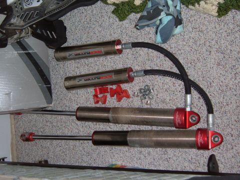 1985 Ford Ranger - Two RaceRunner shock absorbers are laid out on a carpeted surface with mounting hardware and nuts.