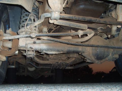 1994 Ford F-150 - Underside view of a 1994 Ford F-150's front axle and suspension system.