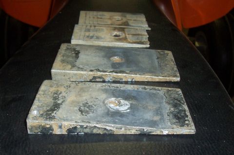 1994 Ford F-150 - These four metal blocks are used to lift a vehicle's suspension.