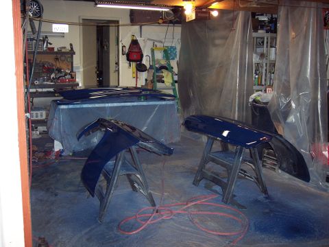 1971 Ford Mustang - Car body panels are prepped and painted in a garage setting, suggesting a restoration or repair project.
